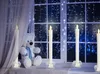 A teddy bear sits on a windowsill next to LED candles, with fairy lights decorating the window. Anteprima dell’immagine prodotto