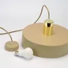 A beige pendant light fixture with a gold accent and a light bulb are shown against a white background. Produktbild-Vorschau