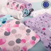 A collection of rolled and folded children's underwear with various patterns and colors, displayed on a light blue and white surface. Produktbild-Vorschau