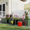 A garden scene with raised garden beds, flowers, gardening tools, and a pressure washer. Voir les images du produit