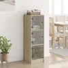 A tall, narrow cabinet with glass doors stands in a room with a plant and a table with chairs in the background. Anteprima dell’immagine prodotto