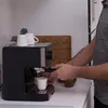 A person is making coffee with an espresso machine. Produktbild-Vorschau