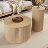 A living room setting with a couch, coffee table, and side table. Voir les images du produit