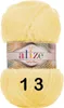 A ball of yellow yarn with a label. Produktbild-Vorschau