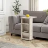 A side table with shelves is placed next to a gray sofa in a living room. Produktbild-Vorschau