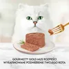 A white cat looks at a plate of cat food, with a fork holding a piece of food. Podgląd zdjęcia produktu