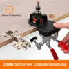 A jig is being used to drill holes for cabinet hinges on a wooden surface. Produktbild-Vorschau