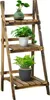 A three-tiered wooden plant stand with plants on each tier. Produktbild-Vorschau
