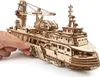 A hand is shown adjusting a wooden model ship. Podgląd zdjęcia produktu