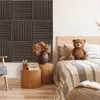 A bedroom scene with acoustic panels on the wall, a bed with a teddy bear, and wooden side tables. Anteprima dell’immagine prodotto