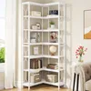 A white corner bookshelf filled with books and decorative items, next to a window with curtains and a part of a sofa and flowers in a vase. Anteprima dell’immagine prodotto