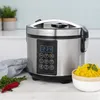 A digital rice cooker and steamer is shown on a countertop with a bowl of rice and some vegetables in the foreground. Produktbild-Vorschau