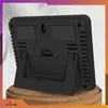 The back of a black digital weather station with a stand, placed on a wooden surface. Anteprima dell’immagine prodotto