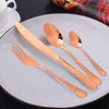 A set of copper-colored cutlery is arranged on a light gray plate. Voir les images du produit