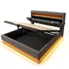 A modern bed frame with the storage compartment open and the mattress support lifted. Produktbild-Vorschau