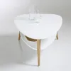 A modern white coffee table with wooden legs and a shelf underneath, displayed on a white background. Náhled obrázku produktu