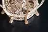 A close-up view of a wooden mechanical puzzle, specifically a part of the uGEARS Mechanisches Aquarium-3D-Puzzle aus Holz. Podgląd zdjęcia produktu