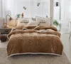 A bedroom scene with a bed made up with a brown comforter and pillows. Produktbild-Vorschau