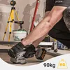 A person is using a tile vibrator on a construction site. Podgląd zdjęcia produktu