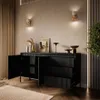A modern living room with a black sideboard and decorative items. Produktbild-Vorschau