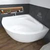 A white corner bathtub is shown in a modern bathroom with dark gray tiled walls and a wooden floor. A recessed shelf above the tub holds decorative items and toiletries. Produktbild-Vorschau