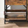 A close-up view of a wooden and metal shoe cabinet with three open flip-down compartments. Náhled obrázku produktu