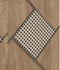 A close-up view of a wooden surface with a diamond-shaped inlay of rattan material. Anteprima dell’immagine prodotto