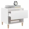 A white nightstand with an open drawer, a cup of coffee, books, and an alarm clock on top. Náhled obrázku produktu