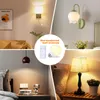 A collage of four images showing different types of wall sconces and a table lamp, with a central inset highlighting a remote-controlled LED bulb. Voir les images du produit