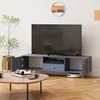 A living room scene featuring a TV stand with a TV, a coffee table with books and cups, a plant, and a robot vacuum cleaner. Produktbild-Vorschau