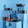 A collection of cookware and kitchen items arranged on blue blocks against a blue background. Voir les images du produit