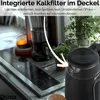 A black electric kettle is shown on a kitchen counter with a blurred background of kitchen appliances and plants. Text overlays describe the product's features. Produktbild-Vorschau