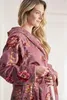 A woman wearing a floral bathrobe. Produktbild-Vorschau