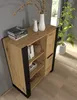 A modern wooden cabinet with black accents, decorated with books and vases, placed in a room with a plant and a window. Podgląd zdjęcia produktu