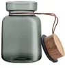 A glass storage jar with a wooden lid and a leather strap. Produktbild-Vorschau