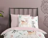 A close-up view of a child's bed with bedding featuring woodland animals. Produktbild-Vorschau