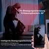 A person dressed as a burglar is shown in a room, with red lines indicating the detection range of a security camera. A smartphone displays a live feed of the burglar. Produktbild-Vorschau