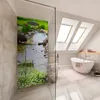 A modern bathroom with a shower enclosure featuring a scenic nature print, a freestanding bathtub, and a toilet. Produktbild-Vorschau