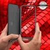 Hands holding a smartphone with a flip case against a red, textured background. Produktbild-Vorschau