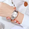 A close-up shot of a woman's wrist wearing a silver watch. Produktbild-Vorschau