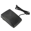 A black sewing machine foot pedal with a cord is shown on a white background. Produktbild-Vorschau