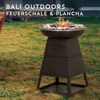 A fire pit with a grill top is set up on a grassy lawn. Produktbild-Vorschau