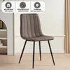 A brown upholstered dining chair with black metal legs is shown in a room with a white bookshelf on the left and a light-colored wall with decorative paneling on the right. Above the chair, there are three circular icons with text, indicating product featu Produktbild-Vorschau