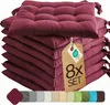 A stack of burgundy seat cushions with a tag indicating an 8-piece set. Voir les images du produit