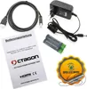 A collection of items including a manual, HDMI cable, power adapter, batteries, and a promotional badge. Náhled obrázku produktu