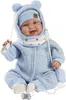 A baby doll dressed in a blue outfit with a hat and scarf, sitting down. Produktbild-Vorschau