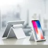 A tablet and a smartphone are displayed on stands on a table. Voir les images du produit
