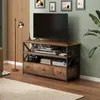 A TV stand with a TV and electronic devices in a living room setting. Podgląd zdjęcia produktu