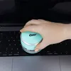 A hand is holding a mint-colored mini vacuum cleaner over a laptop keyboard. Anteprima dell’immagine prodotto
