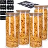 A set of four glass storage jars filled with cereal, with a stack of chalk labels in the background. Produktbild-Vorschau